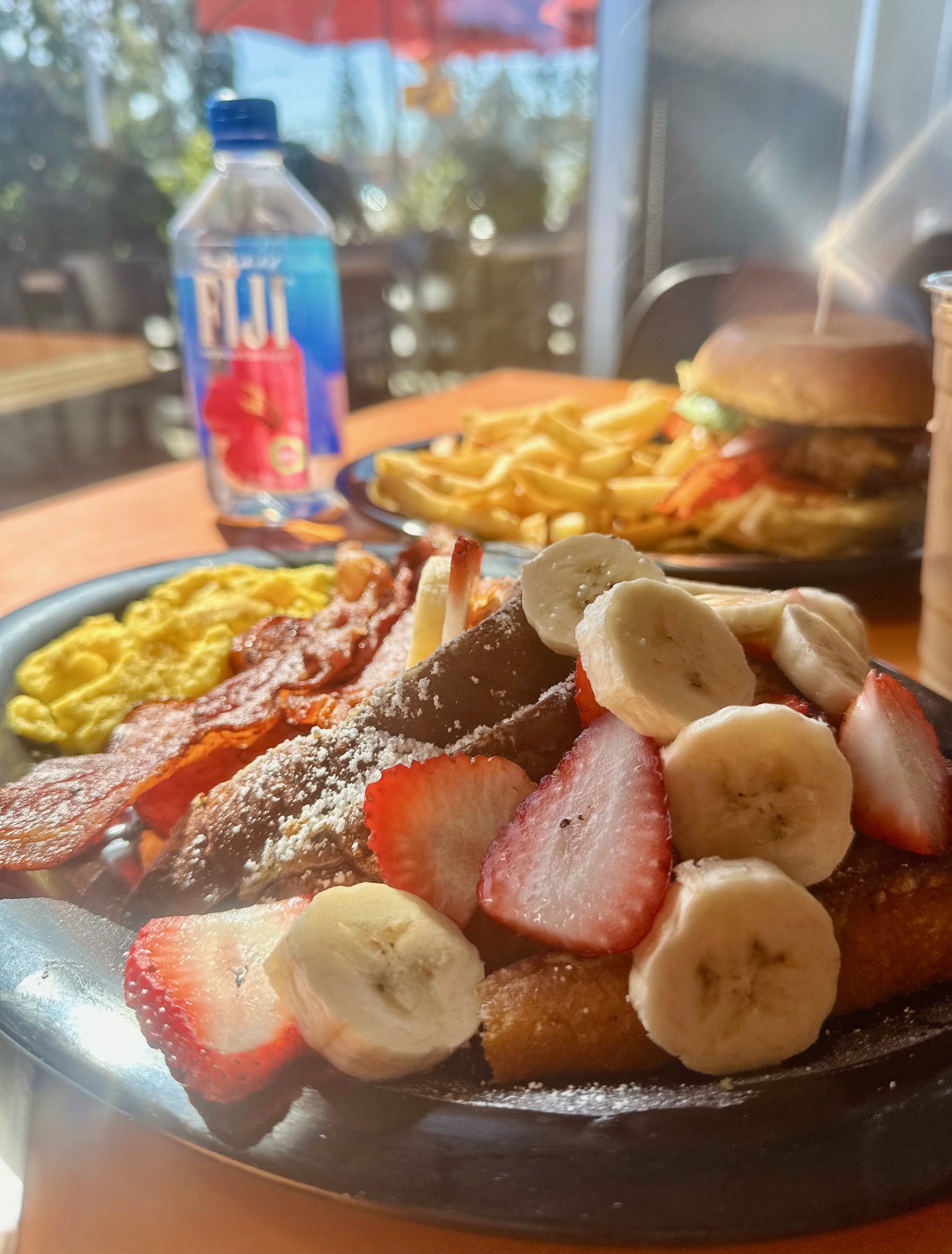 Strawberry and banana French toast with eggs and bacon at Rooster Cafe